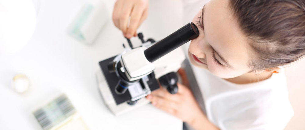 Student Looking Through Microscope
